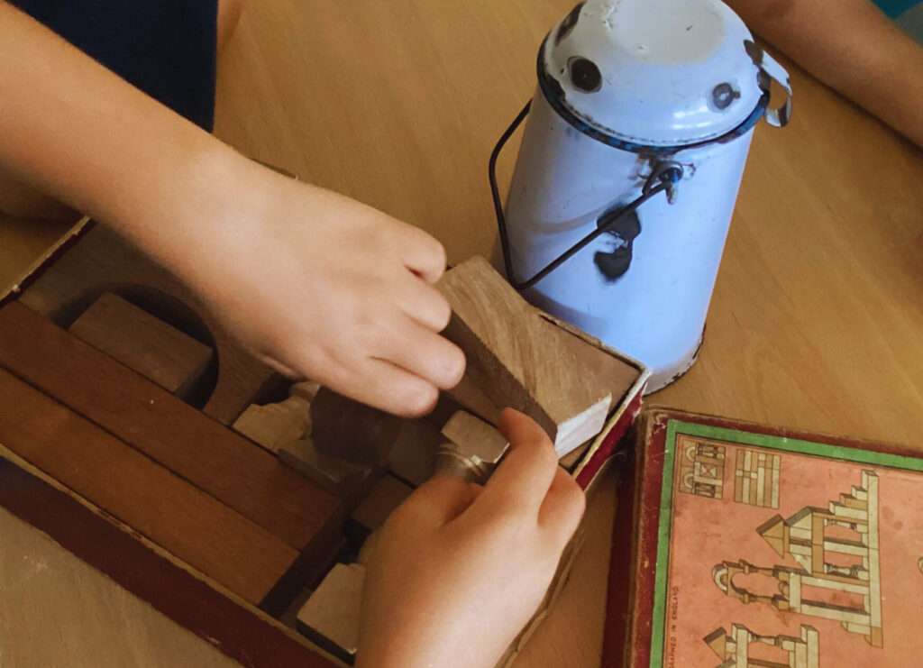 Child exploring historical artefacts during a hands-on history activity.